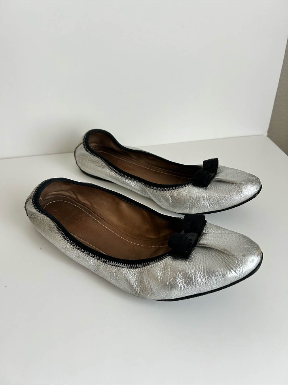 Salvatore Ferragamo Silver Leather Ballet Flats with Black Trim and Bow